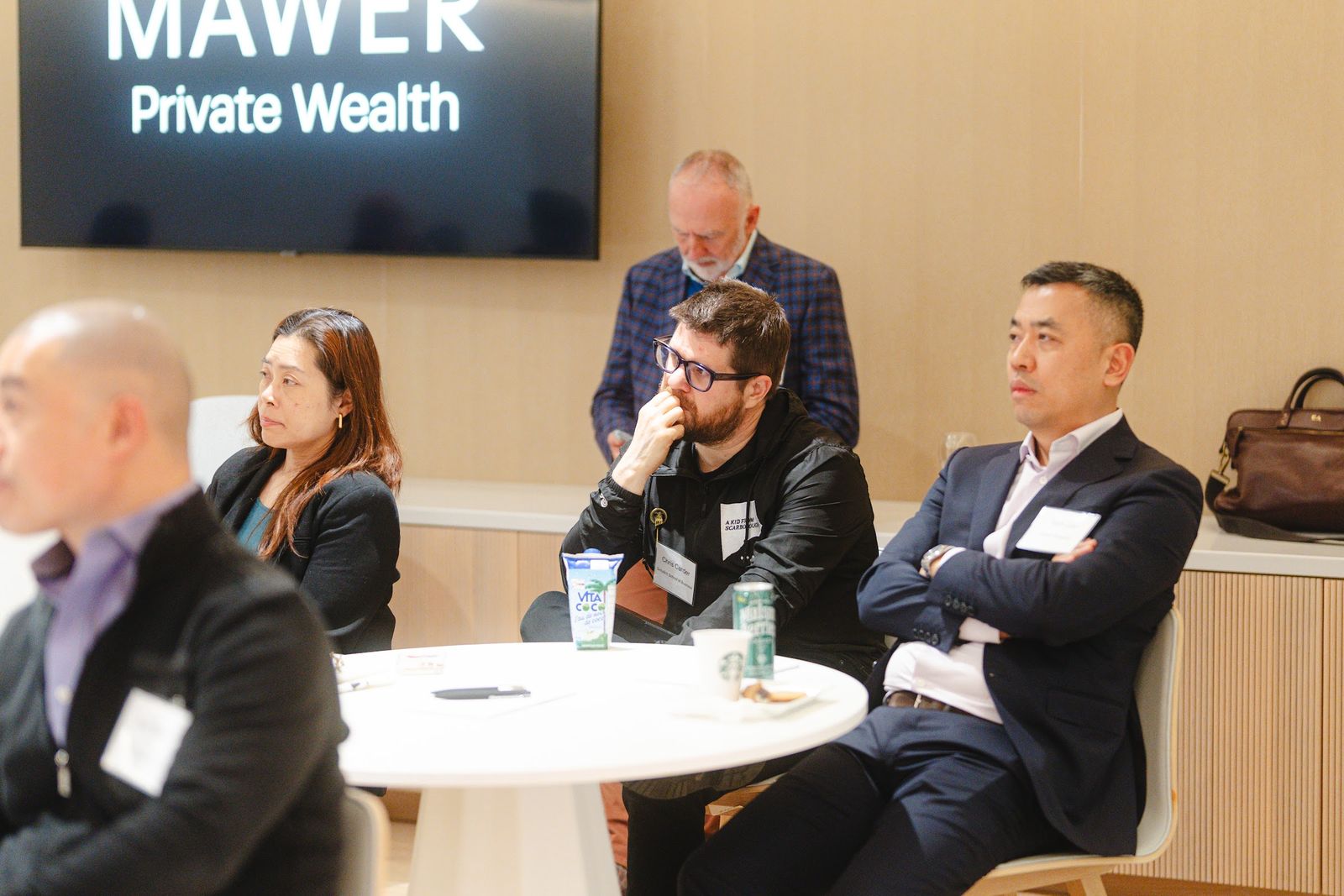 Guests seated around tables during a discussion